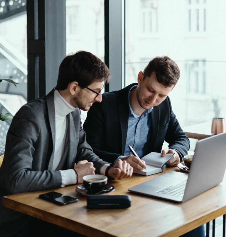 Two young businessman having a successful meeting at restaurant.